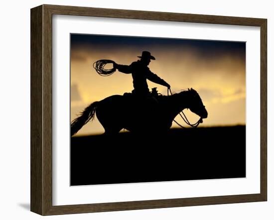 A Silhouetted Cowboy Riding Alone a Ridge at Sunset in Shell, Wyoming, USA-Joe Restuccia III-Framed Photographic Print