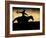 A Silhouetted Cowboy Riding Alone a Ridge at Sunset in Shell, Wyoming, USA-Joe Restuccia III-Framed Photographic Print