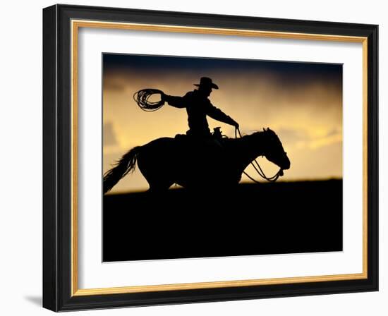 A Silhouetted Cowboy Riding Alone a Ridge at Sunset in Shell, Wyoming, USA-Joe Restuccia III-Framed Photographic Print