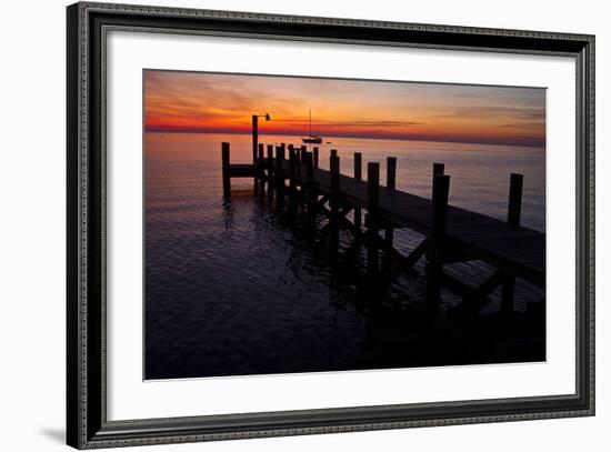 A Single Sailboat Sits on the Water of the Bay Alongside an Empty Dock on Tilghman Island, Maryland-Karine Aigner-Framed Photographic Print