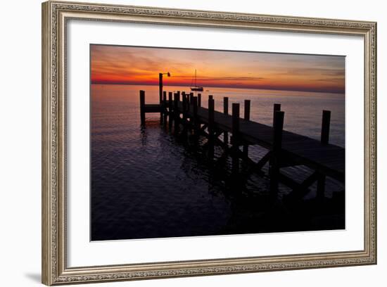 A Single Sailboat Sits on the Water of the Bay Alongside an Empty Dock on Tilghman Island, Maryland-Karine Aigner-Framed Photographic Print