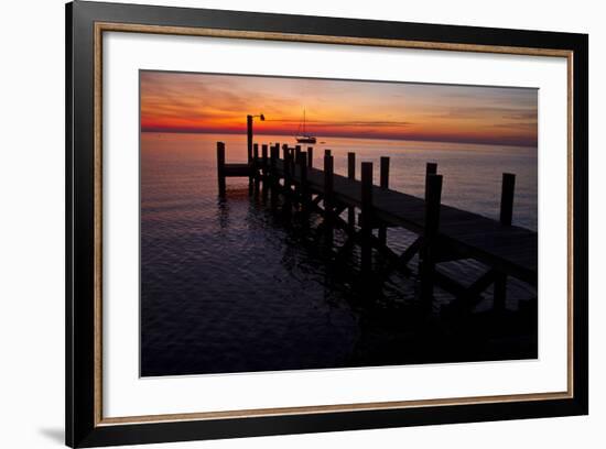 A Single Sailboat Sits on the Water of the Bay Alongside an Empty Dock on Tilghman Island, Maryland-Karine Aigner-Framed Photographic Print