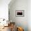 A Single Sailboat Sits on the Water of the Bay Alongside an Empty Dock on Tilghman Island, Maryland-Karine Aigner-Framed Photographic Print displayed on a wall