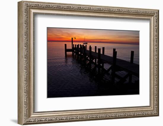 A Single Sailboat Sits on the Water of the Bay Alongside an Empty Dock on Tilghman Island, Maryland-Karine Aigner-Framed Photographic Print