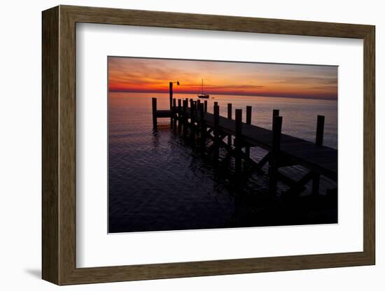 A Single Sailboat Sits on the Water of the Bay Alongside an Empty Dock on Tilghman Island, Maryland-Karine Aigner-Framed Photographic Print