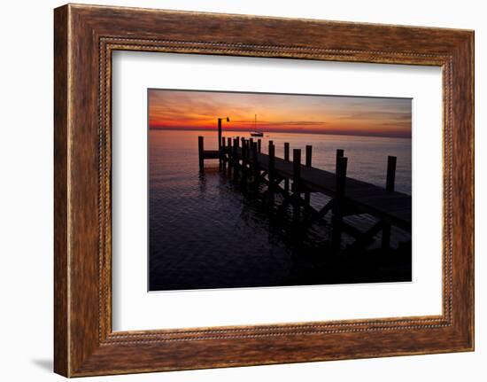 A Single Sailboat Sits on the Water of the Bay Alongside an Empty Dock on Tilghman Island, Maryland-Karine Aigner-Framed Photographic Print