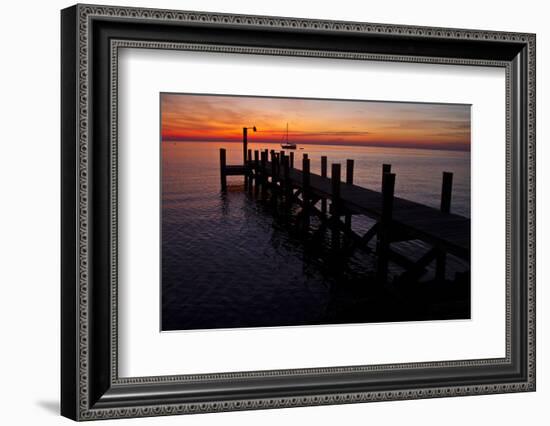 A Single Sailboat Sits on the Water of the Bay Alongside an Empty Dock on Tilghman Island, Maryland-Karine Aigner-Framed Photographic Print