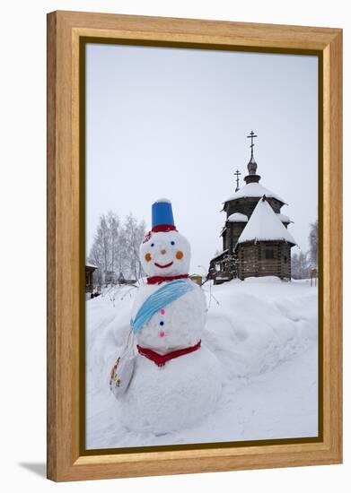 A Snowman and a Wooden Church at the Museum of Wooden Architecture and Peasants' Life-null-Framed Premier Image Canvas