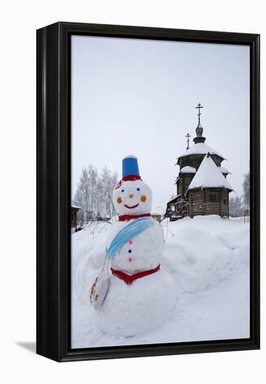 A Snowman and a Wooden Church at the Museum of Wooden Architecture and Peasants' Life-null-Framed Premier Image Canvas