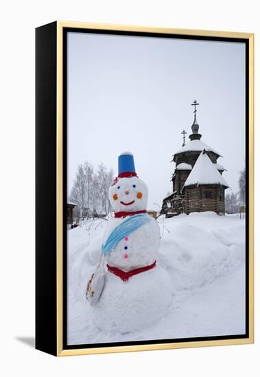 A Snowman and a Wooden Church at the Museum of Wooden Architecture and Peasants' Life-null-Framed Premier Image Canvas