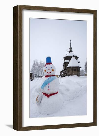 A Snowman and a Wooden Church at the Museum of Wooden Architecture and Peasants' Life-null-Framed Photographic Print