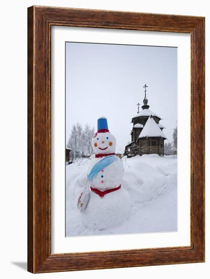 A Snowman and a Wooden Church at the Museum of Wooden Architecture and Peasants' Life-null-Framed Photographic Print