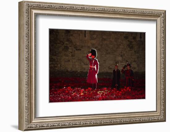 A soldier salutes in the midst of poppies at the Tower of London-Associated Newspapers-Framed Photo