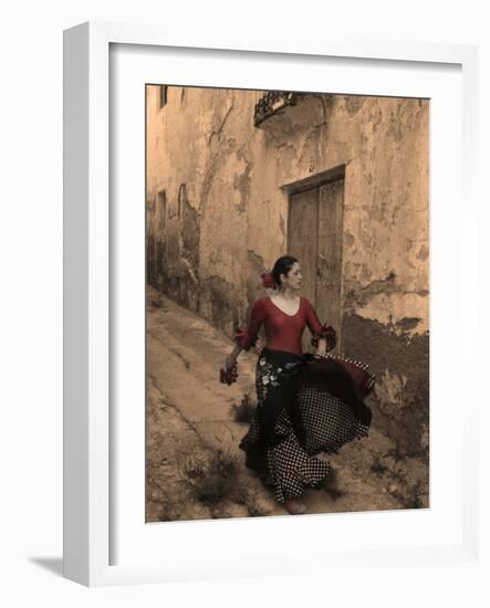 A Spanish Woman Walking Along a Traditional Spanish Street Wearing a Flamenco Style Dress-Steven Boone-Framed Photographic Print