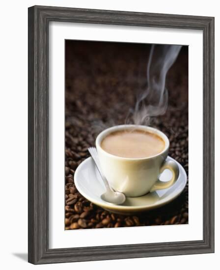 A Steaming Cup of Coffee on Coffee Beans-Peter Sapper-Framed Photographic Print