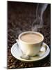 A Steaming Cup of Coffee on Coffee Beans-Peter Sapper-Mounted Photographic Print