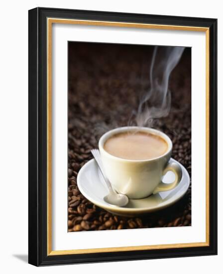 A Steaming Cup of Coffee on Coffee Beans-Peter Sapper-Framed Photographic Print