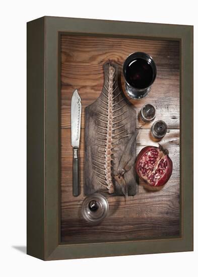 A Still Life Featuring a Fish Skeleton, Pomegranate and Red Wine-Komar-Framed Premier Image Canvas