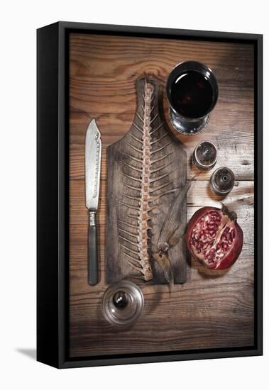 A Still Life Featuring a Fish Skeleton, Pomegranate and Red Wine-Komar-Framed Premier Image Canvas