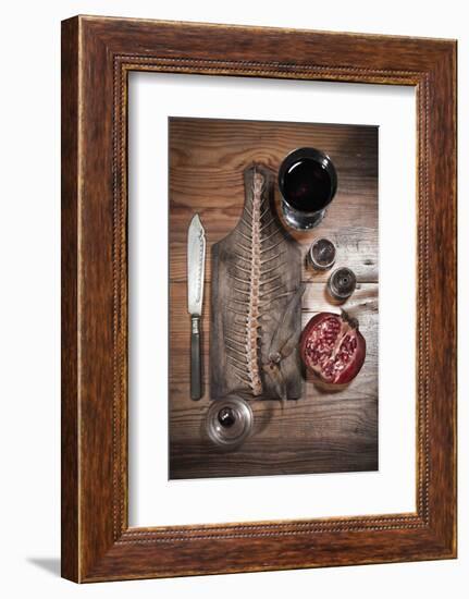 A Still Life Featuring a Fish Skeleton, Pomegranate and Red Wine-Komar-Framed Photographic Print