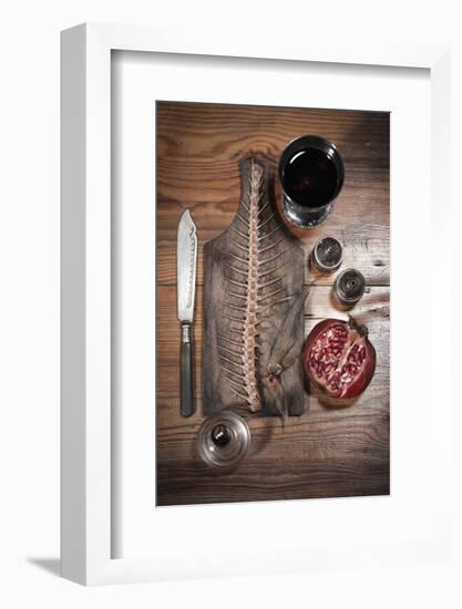 A Still Life Featuring a Fish Skeleton, Pomegranate and Red Wine-Komar-Framed Photographic Print