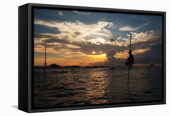 A Stilt Fisherman at Sunset-Alex Saberi-Framed Premier Image Canvas