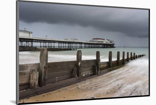 A stormy sky over the beach and pier at Cromer, Norfolk, England, United Kingdom, Europe-Jon Gibbs-Mounted Photographic Print