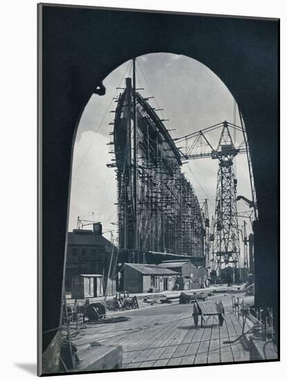 'A striking bow view of the giant Cunard liner, Queen Mary, at Clydebank, Glasgow', 1934-Unknown-Mounted Photographic Print