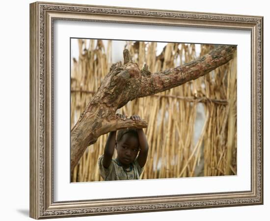 A Sudanese Girl Plays Inside a Thatched Hut at the Refugee Camp of Zamzam-null-Framed Photographic Print