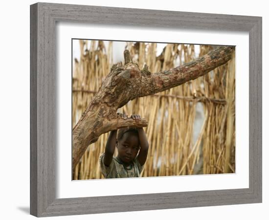 A Sudanese Girl Plays Inside a Thatched Hut at the Refugee Camp of Zamzam-null-Framed Photographic Print