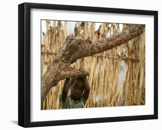 A Sudanese Girl Plays Inside a Thatched Hut at the Refugee Camp of Zamzam-null-Framed Photographic Print