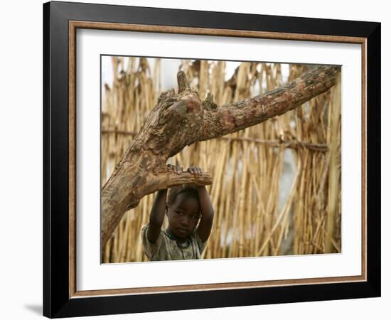 A Sudanese Girl Plays Inside a Thatched Hut at the Refugee Camp of Zamzam-null-Framed Photographic Print