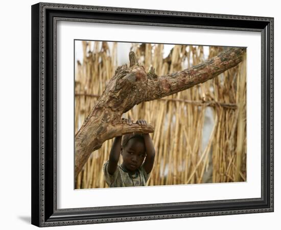 A Sudanese Girl Plays Inside a Thatched Hut at the Refugee Camp of Zamzam-null-Framed Photographic Print