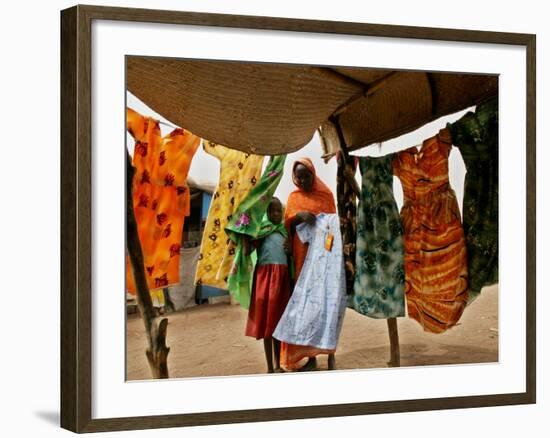 A Sudanese Woman Buys a Dress for Her Daughter at the Zamzam Refugee Camp--Framed Photographic Print