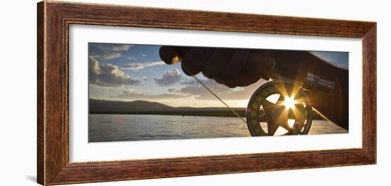 A Sunset Sunstart Through the Fly Reel of an Angler on the Henry's Fork River in Idaho.-Clint Losee-Framed Photographic Print