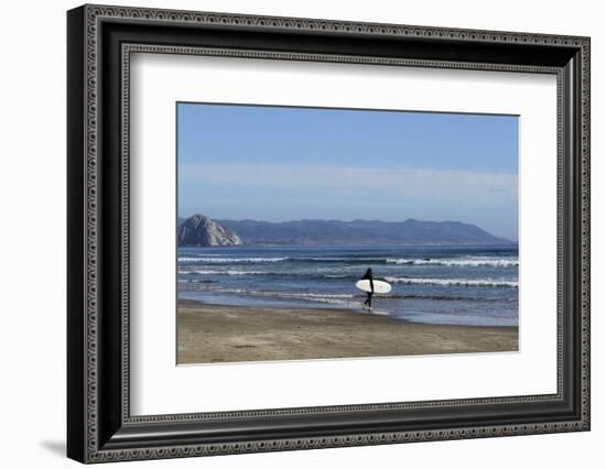 A surfer approaches the water, Morro Rock in the background. San Luis Obispo County, California, Us-Susan Pease-Framed Photographic Print