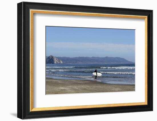 A surfer approaches the water, Morro Rock in the background. San Luis Obispo County, California, Us-Susan Pease-Framed Photographic Print