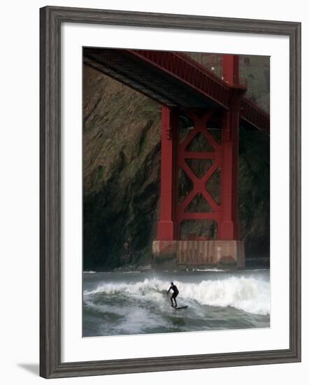 A Surfer is Dwarfed by the Northern End of the Golden Gate Bridge While Riding the Waves-null-Framed Photographic Print