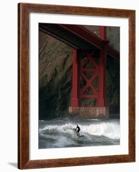 A Surfer is Dwarfed by the Northern End of the Golden Gate Bridge While Riding the Waves-null-Framed Photographic Print