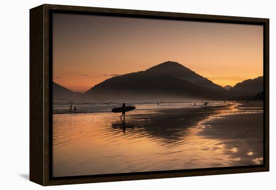 A Surfer Makes His Way Out of the Water at Sunset on Praia Do Itamambuca in Brazil-Alex Saberi-Framed Premier Image Canvas