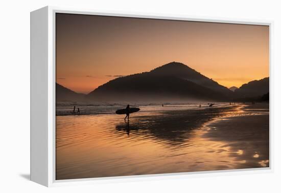 A Surfer Makes His Way Out of the Water at Sunset on Praia Do Itamambuca in Brazil-Alex Saberi-Framed Premier Image Canvas