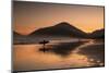 A Surfer Makes His Way Out of the Water at Sunset on Praia Do Itamambuca in Brazil-Alex Saberi-Mounted Photographic Print