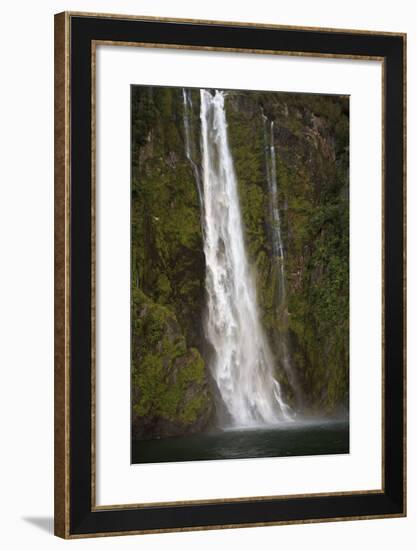 A Tall Waterfall Drops Off a Steep Cliff into Waters, Milford Sound on South Island, New Zealand-Paul Dymond-Framed Photographic Print