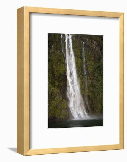A Tall Waterfall Drops Off a Steep Cliff into Waters, Milford Sound on South Island, New Zealand-Paul Dymond-Framed Photographic Print