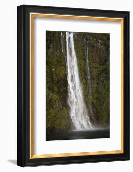 A Tall Waterfall Drops Off a Steep Cliff into Waters, Milford Sound on South Island, New Zealand-Paul Dymond-Framed Photographic Print