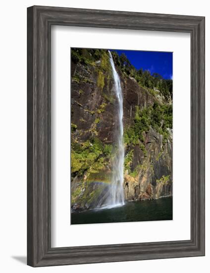 A Tall Waterfall Drops Off a Steep Cliff into Waters, Milford Sound on South Island, New Zealand-Paul Dymond-Framed Photographic Print