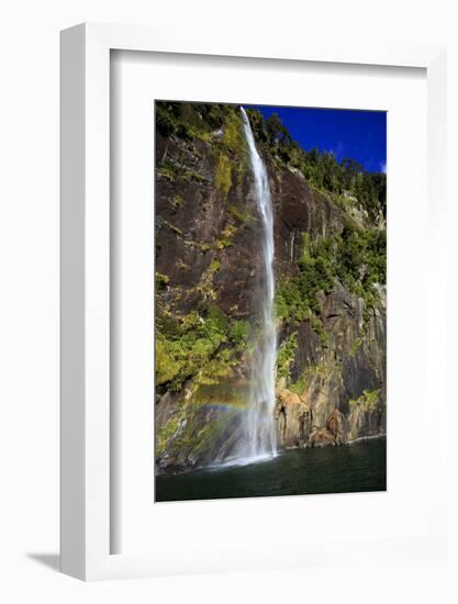 A Tall Waterfall Drops Off a Steep Cliff into Waters, Milford Sound on South Island, New Zealand-Paul Dymond-Framed Photographic Print