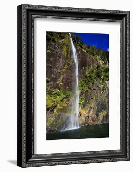 A Tall Waterfall Drops Off a Steep Cliff into Waters, Milford Sound on South Island, New Zealand-Paul Dymond-Framed Photographic Print