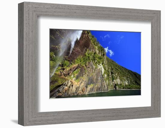 A Tall Waterfall Drops Off a Steep Cliff into Waters, Milford Sound on South Island, New Zealand-Paul Dymond-Framed Photographic Print