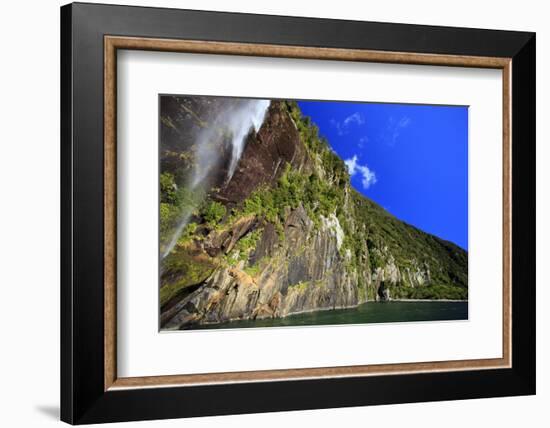 A Tall Waterfall Drops Off a Steep Cliff into Waters, Milford Sound on South Island, New Zealand-Paul Dymond-Framed Photographic Print